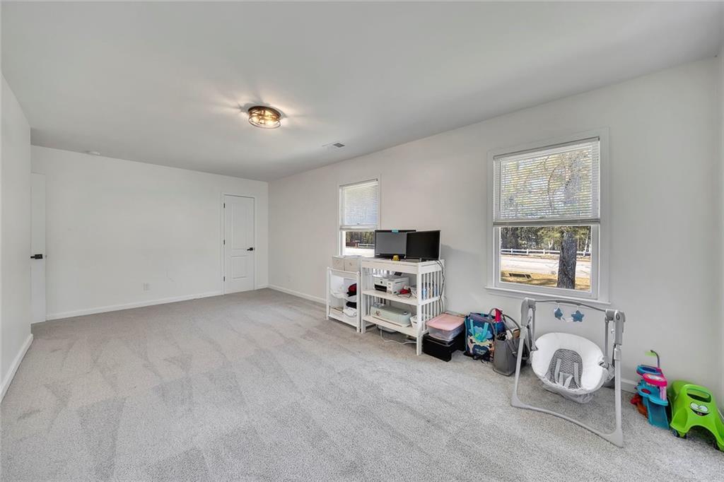 2328 Carnes Road Jonesboro, GA 30236 - Photo 24 of 36 a view of a livingroom with furniture and a flat screen tv