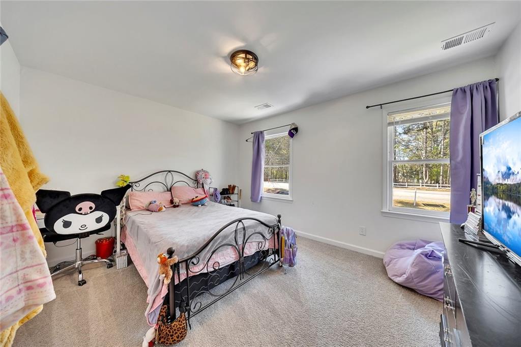 2328 Carnes Road Jonesboro, GA 30236 - Photo 25 of 36 a bedroom with a bed and a window