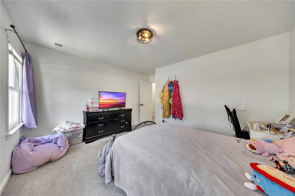 2328 Carnes Road Jonesboro, GA 30236 - Photo 26 of 36 a bedroom with a bed and a window