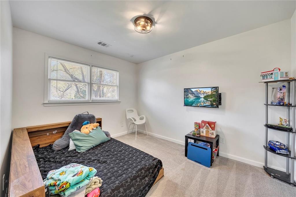 2328 Carnes Road Jonesboro, GA 30236 - Photo 27 of 36 a bed room with furniture and a window