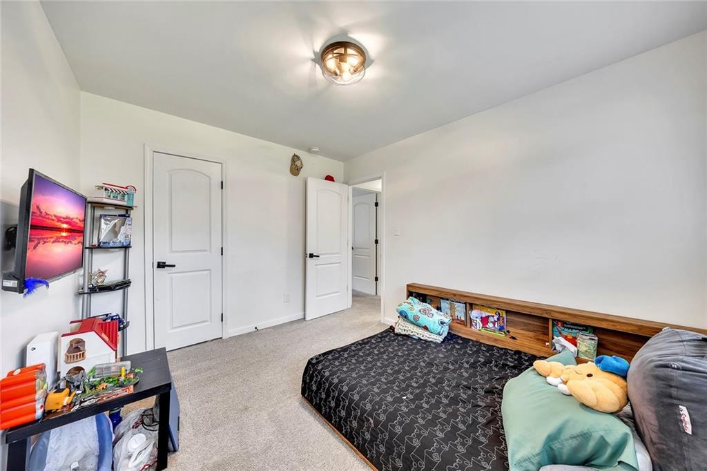 2328 Carnes Road Jonesboro, GA 30236 - Photo 28 of 36 a bed room with a bed and a television