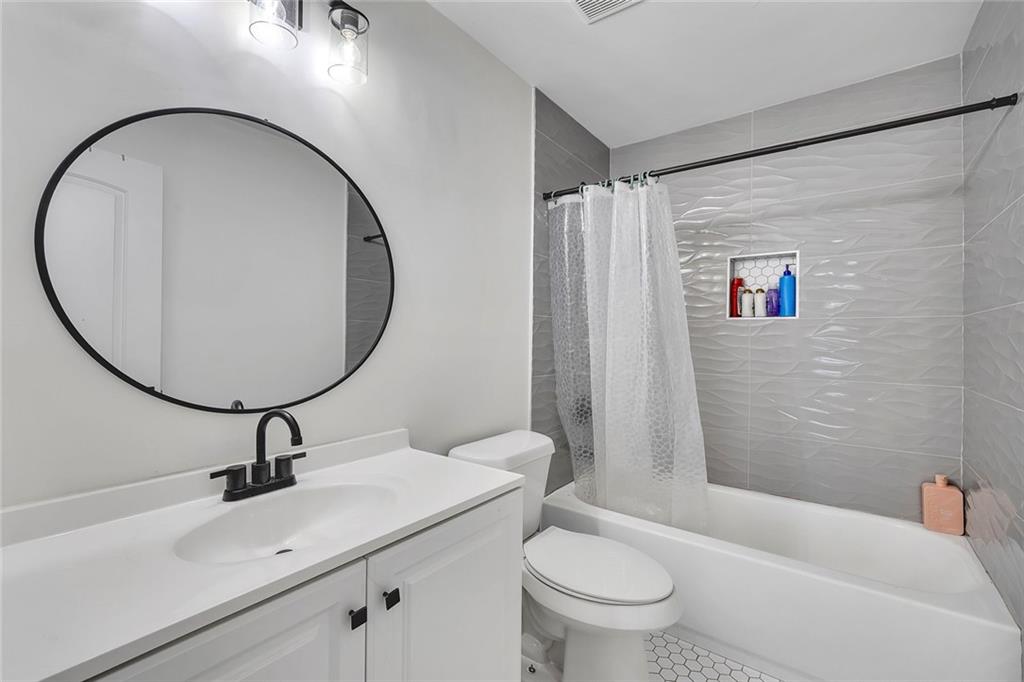 2328 Carnes Road Jonesboro, GA 30236 - Photo 29 of 36 a bathroom with a sink a toilet and a mirror