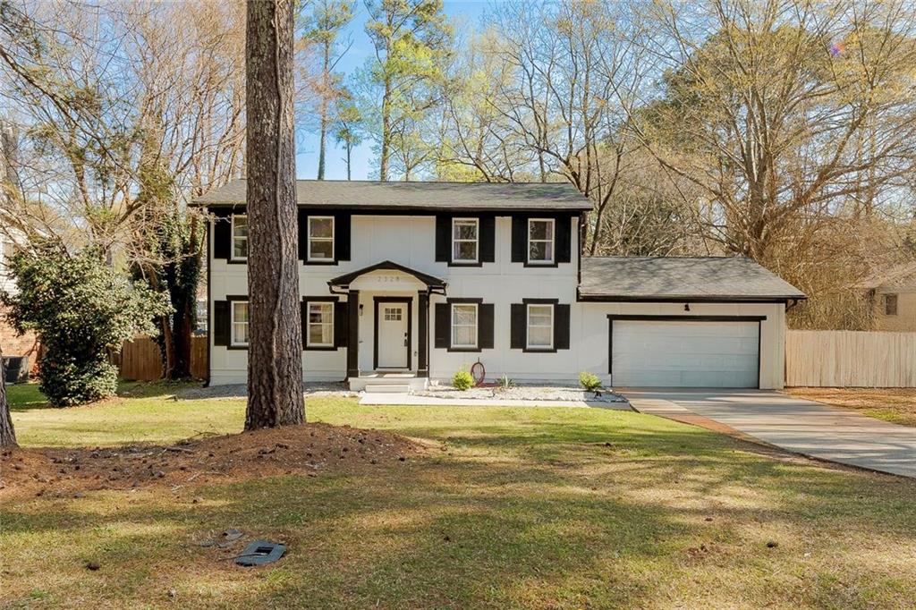 2328 Carnes Road Jonesboro, GA 30236 - Photo 3 of 36 a front view of a house with a yard