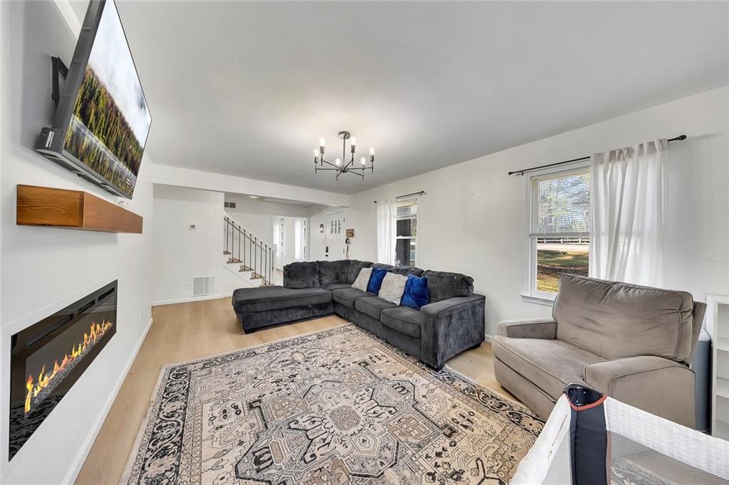 2328 Carnes Road Jonesboro, GA 30236 - Photo 7 of 36 a living room with furniture and a fireplace