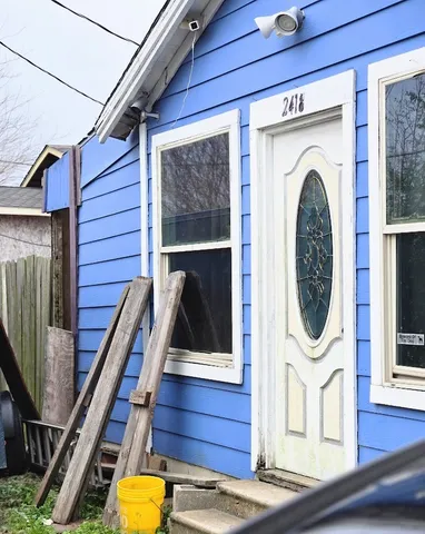 a view of a door with wooden floor and a sink
