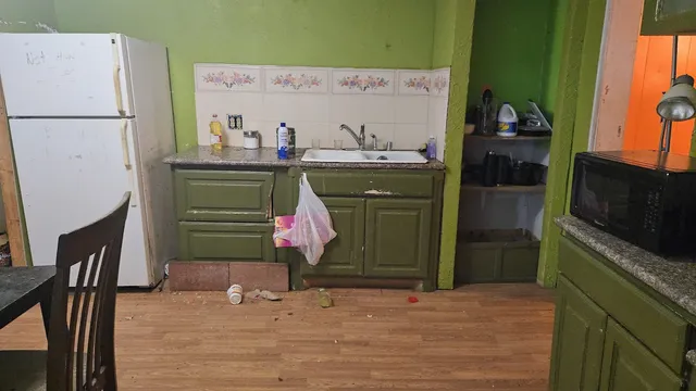 a kitchen with stainless steel appliances a refrigerator and a stove