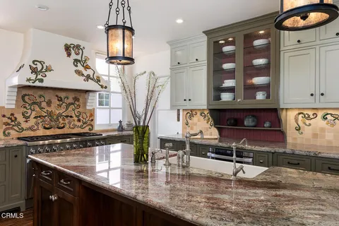 a kitchen with sink cabinets and wooden floor