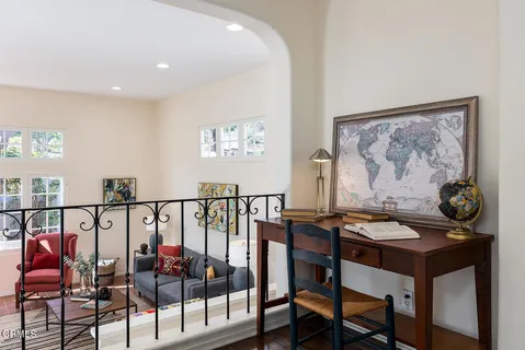 a living room with furniture a fireplace and a large window