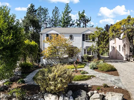 a view of a house with a yard and sitting area