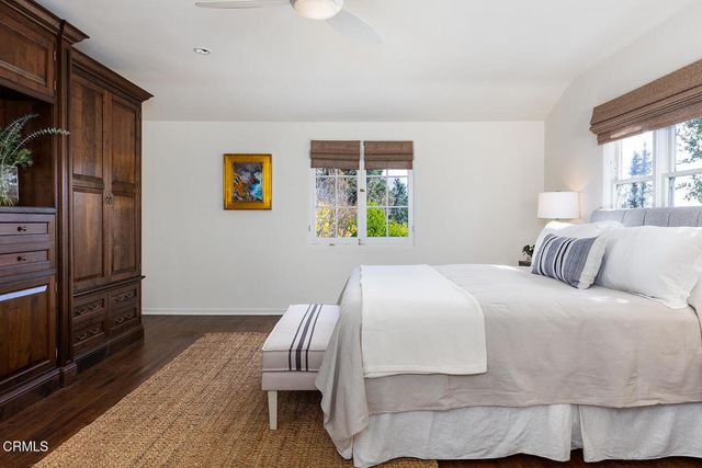 a bedroom with a bed and a chair