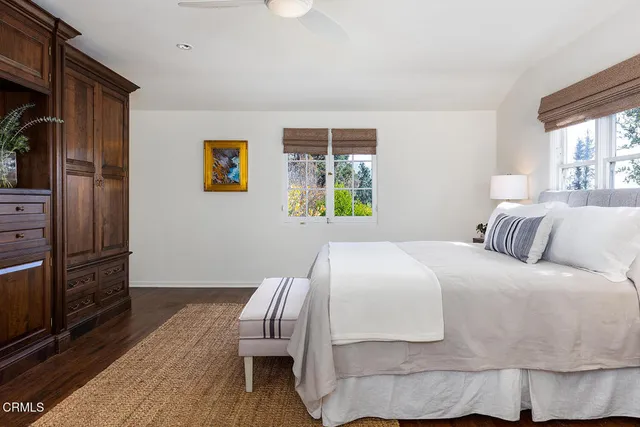 a bedroom with a bed and a chair