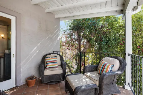 a bedroom with a bed table and a window