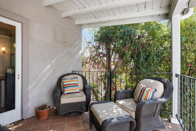 a bedroom with a bed table and a window