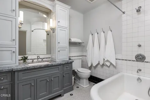 a bedroom with a large bed and a couch