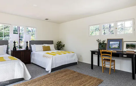 a bedroom with furniture and a window