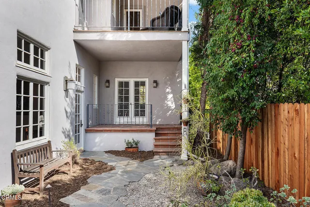 a patio with yard glass top table and chairs