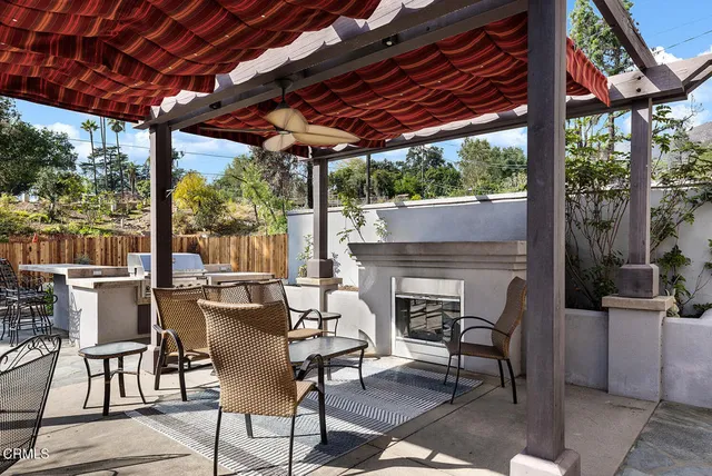 a building outdoor space with patio furniture and a fireplace