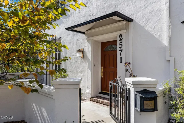 a view of a patio with table and chairs and potted plants