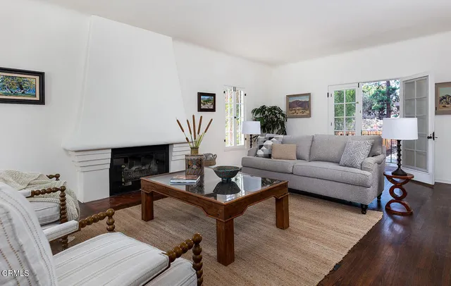 a living room with furniture potted plant and a window