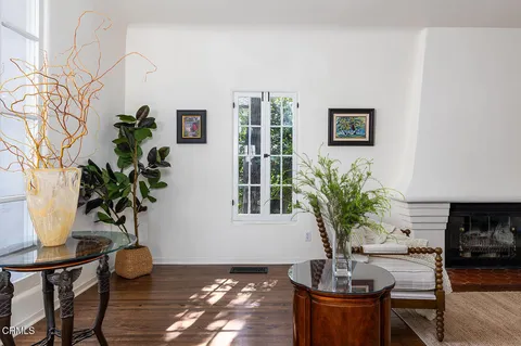 a living room with furniture a wooden floor and a window