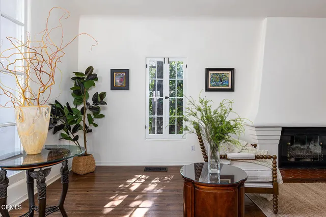 a living room with furniture a wooden floor and a window