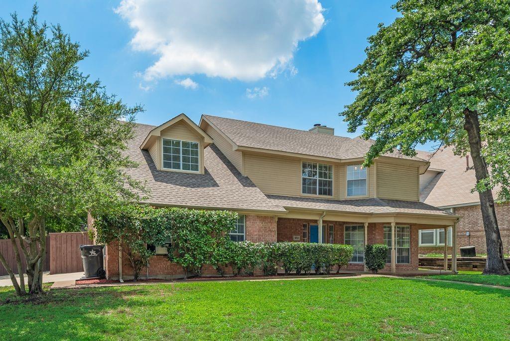 5610 Eagle Rock Road Arlington, TX 76017 - Photo 2 of 33 Two-story residence featuring a brick and siding exterior, a covered front porch, dormer windows, a gabled roofline, and mature landscaping