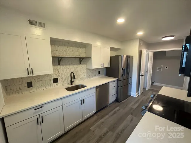 a kitchen with a sink stainless steel appliances and cabinets
