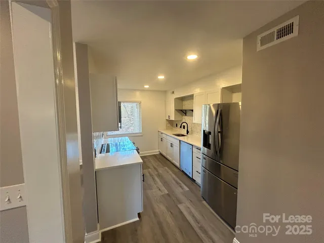 a kitchen with refrigerator and microwave