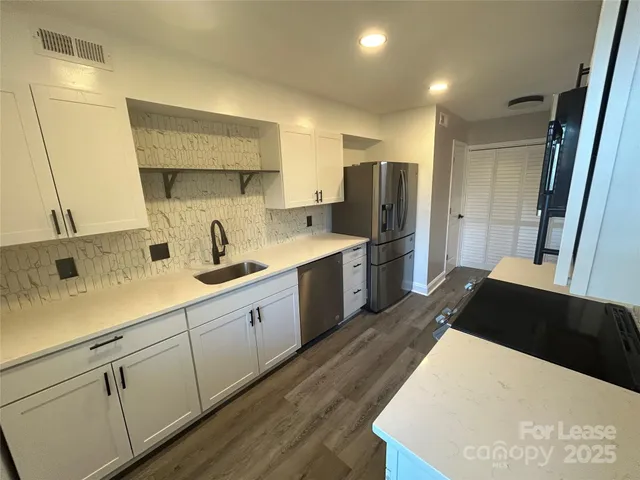 a kitchen with stainless steel appliances a refrigerator and sink