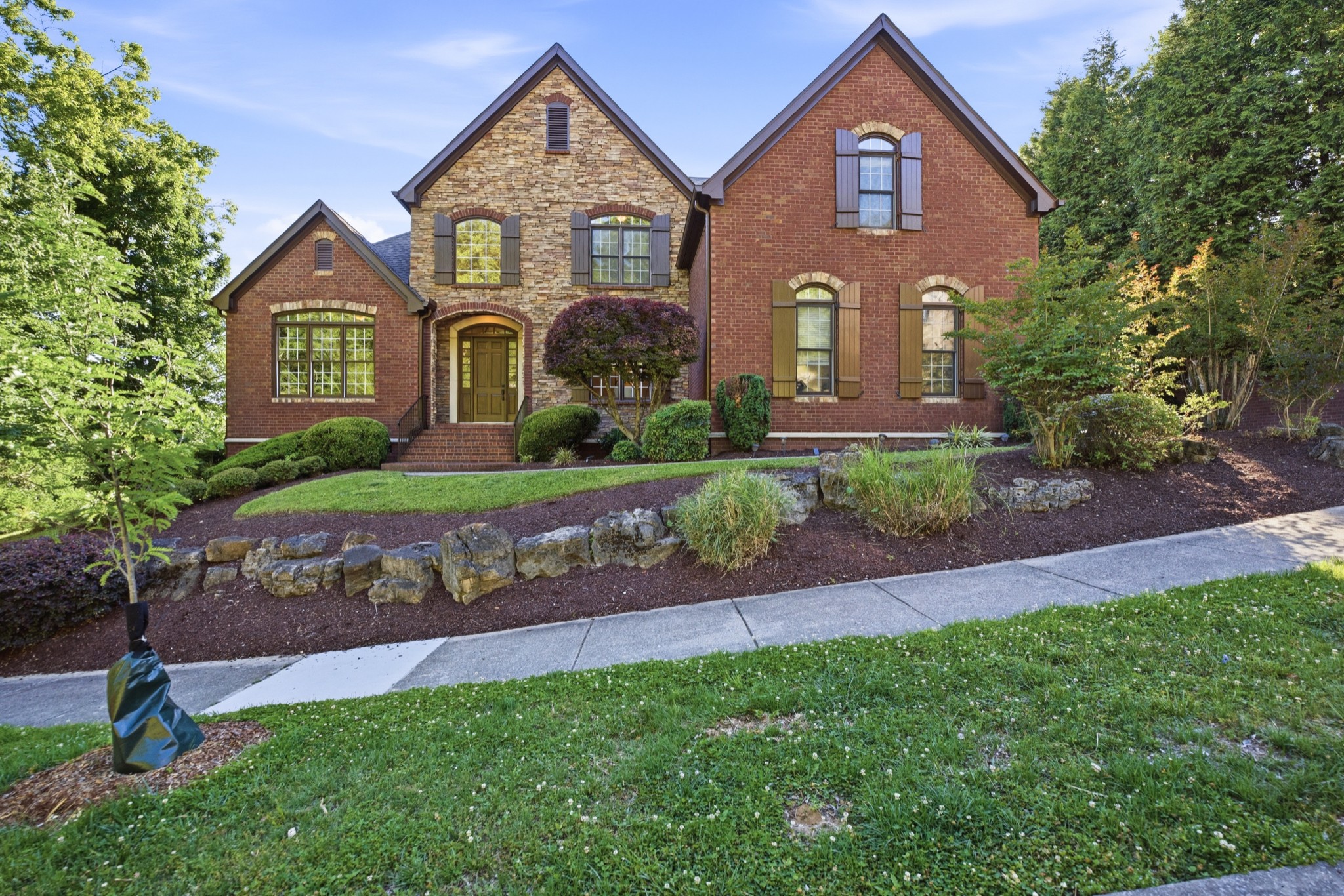 319 Hamlets End Way Franklin, TN 37067 - Photo 1 of 54 a front view of a house with a yard and garage