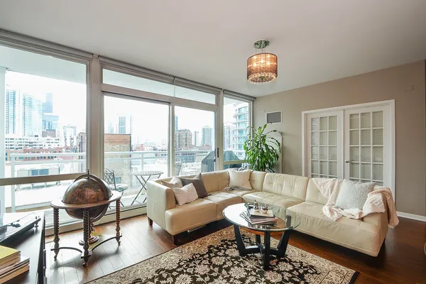 a living room with furniture and a floor to ceiling window