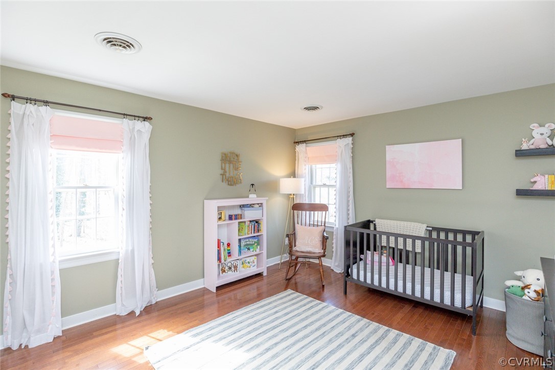 12701 Foxstone Road Midlothian, VA 23113 - Photo 19 of 34 a view of a bedroom with wooden floor & furniture