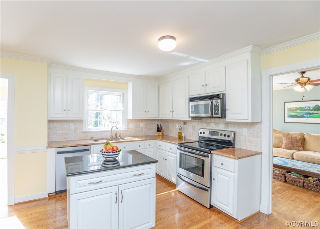 12701 Foxstone Road Midlothian, VA 23113 - Photo 3 of 34 a kitchen with stainless steel appliances granite countertop a stove a sink and a refrigerator