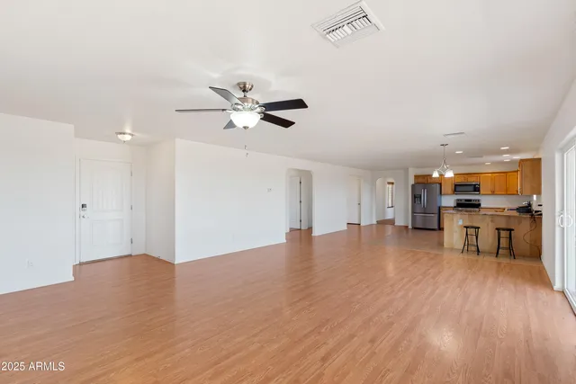 a kitchen with stainless steel appliances granite countertop a refrigerator and a stove top oven