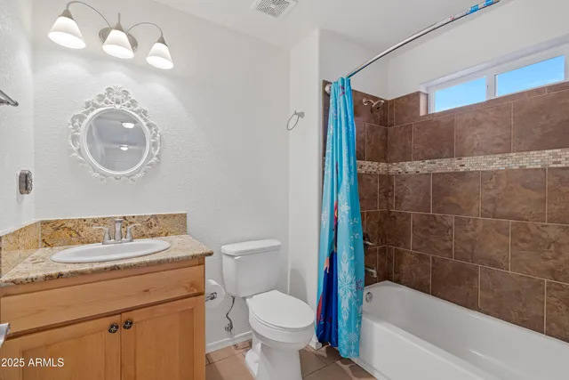 an empty room with a window and a ceiling fan