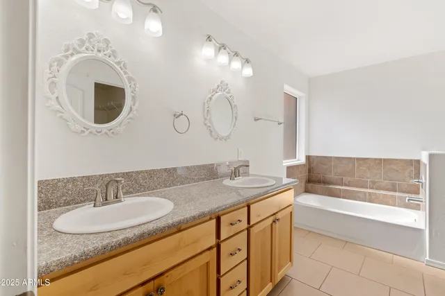 a bathroom with a double vanity sink and a mirror