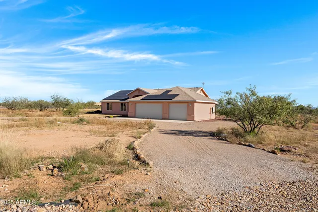 a view of a house with a snow in the background