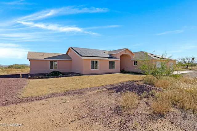 a view of a livingroom with furniture wooden floor and a ceiling fan