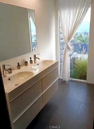 a spacious bathroom with a double vanity sink and a mirror