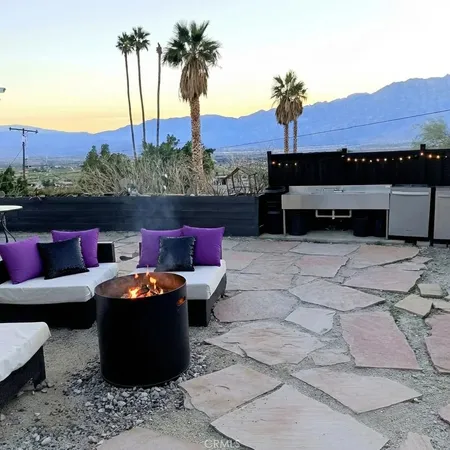 a view of a backyard with sitting area