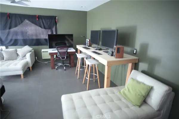 a bedroom with furniture and a large window