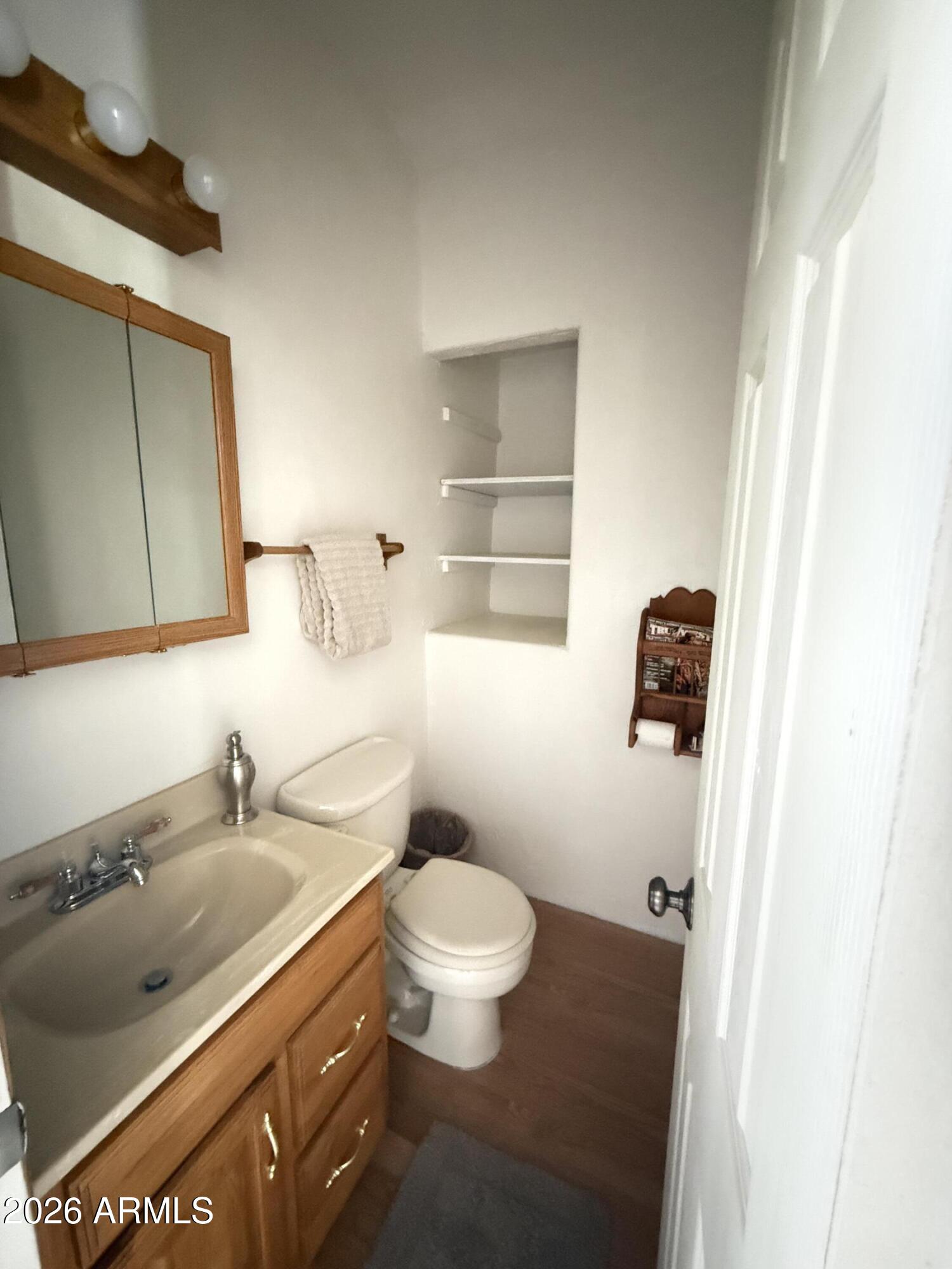 22406 South Eagle Mine Road Crown King, AZ 86343 - Photo 11 of 20 a bathroom with a granite countertop sink a toilet and a mirror