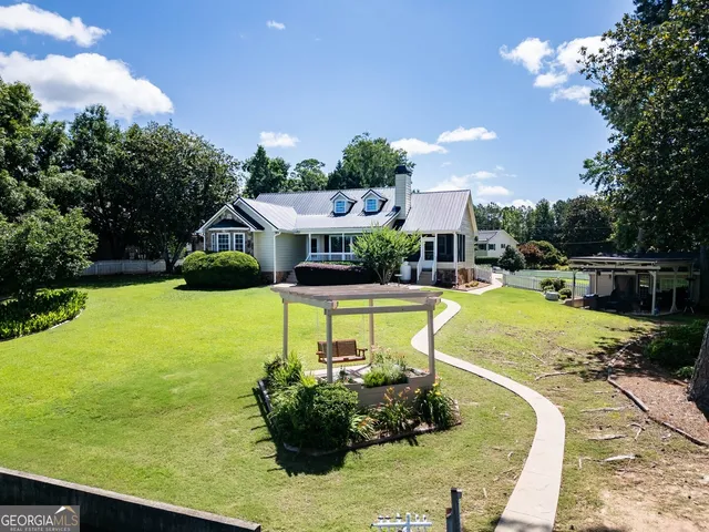 an aerial view of a house with a lake view