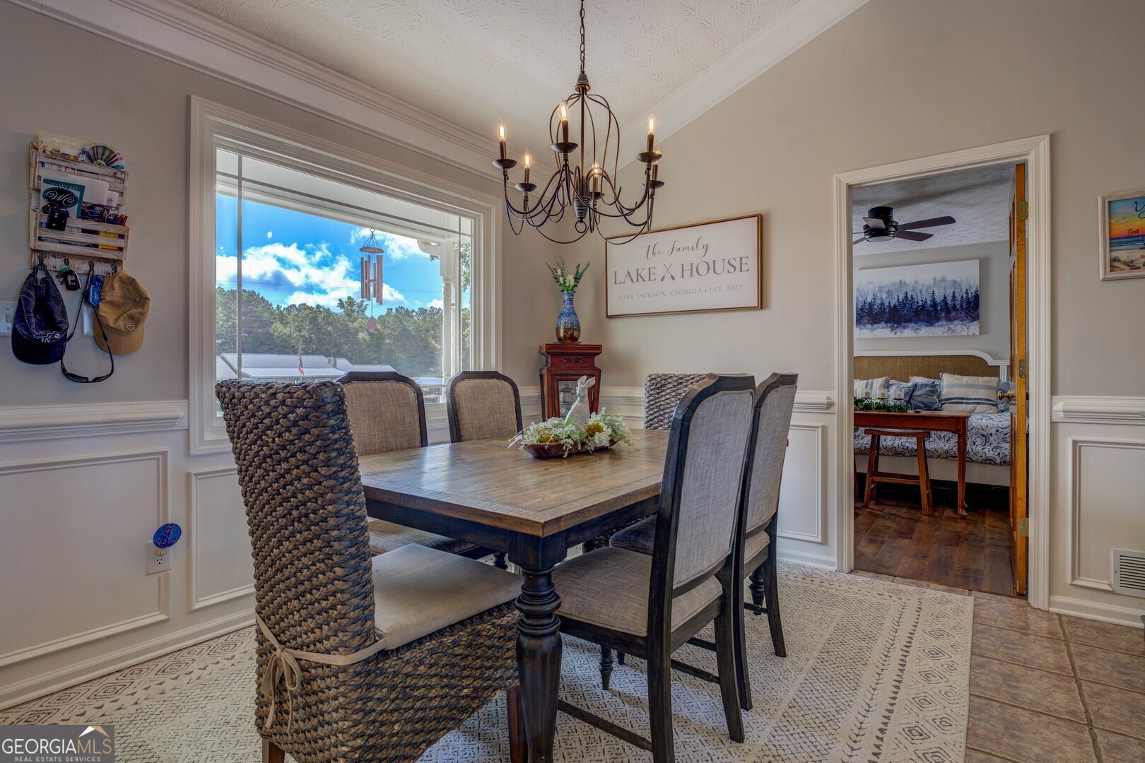 8950 Jackson Lake Road Monticello, GA 31064 - Photo 16 of 88 a view of a dining room with furniture wooden floor and a chandelier