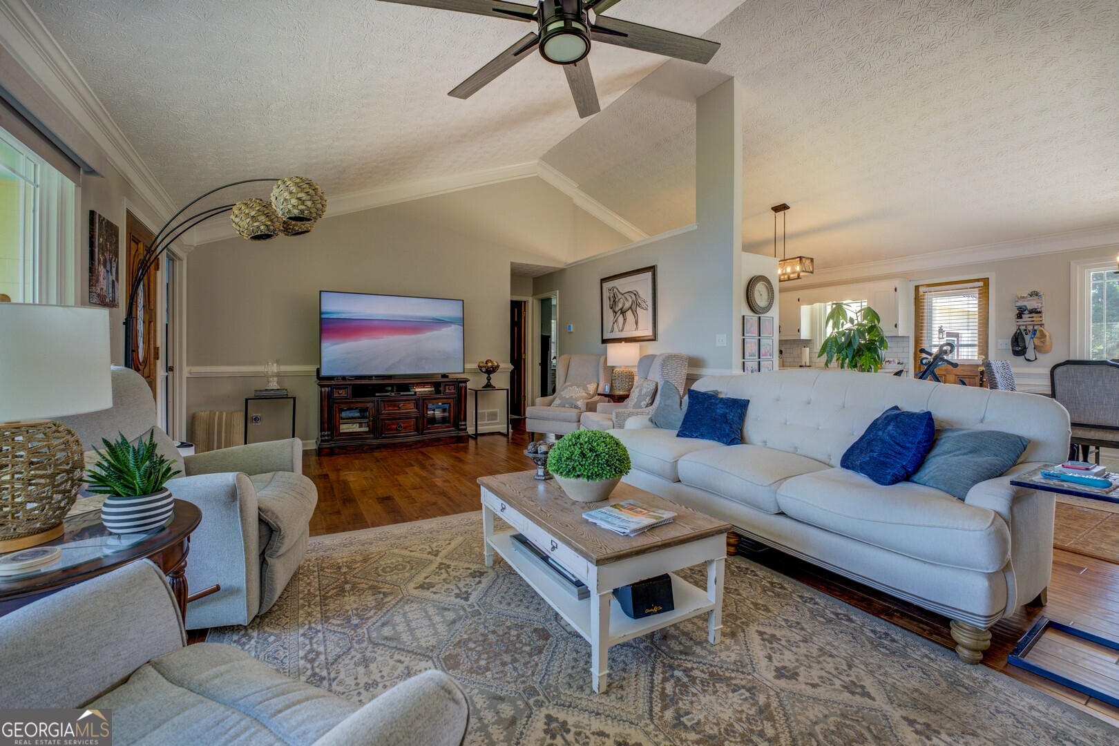 8950 Jackson Lake Road Monticello, GA 31064 - Photo 25 of 88 a living room with furniture a fireplace and a flat screen tv