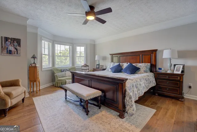 a bedroom with furniture and a wooden floor