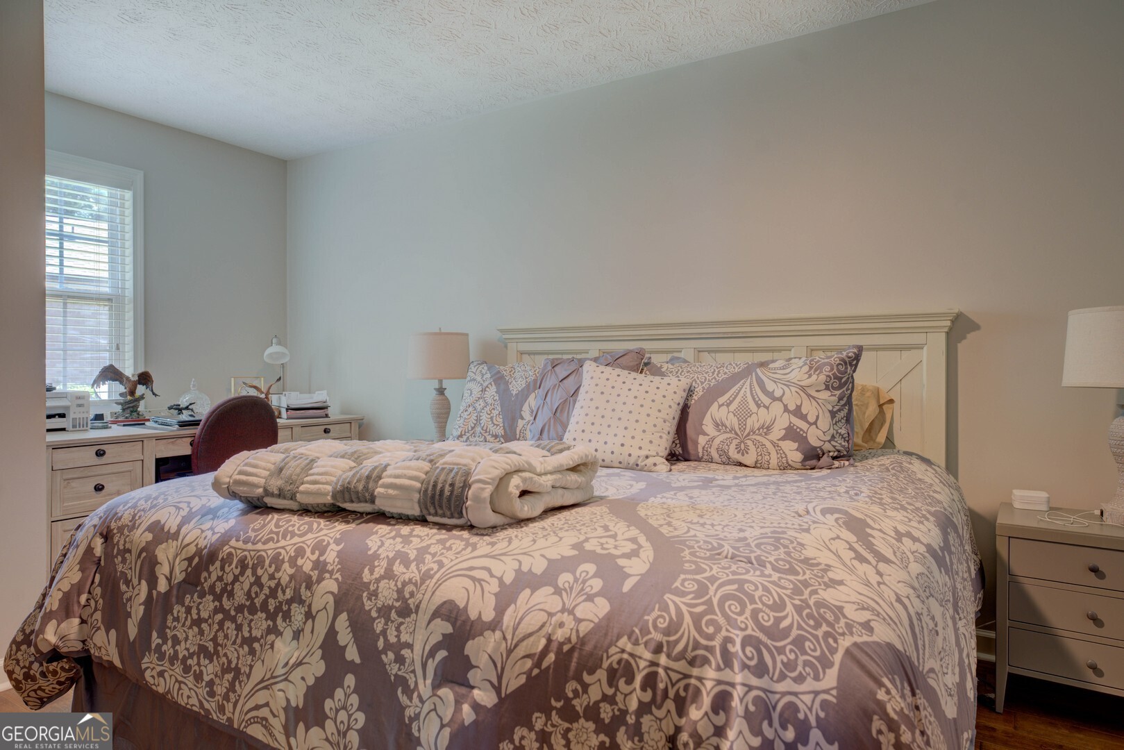 8950 Jackson Lake Road Monticello, GA 31064 - Photo 34 of 88 a bedroom with a large bed and a potted plant