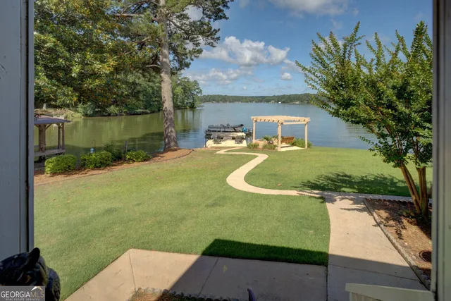 a view of a patio with table and chairs under an umbrella