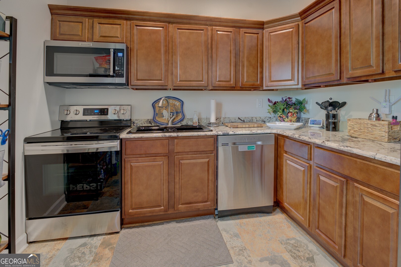 8950 Jackson Lake Road Monticello, GA 31064 - Photo 49 of 88 a kitchen with stainless steel appliances granite countertop a stove microwave and cabinets