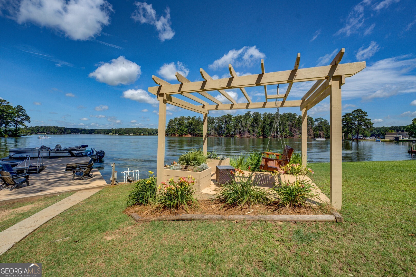 8950 Jackson Lake Road Monticello, GA 31064 - Photo 75 of 88 a view of a patio with table and chairs under an umbrella